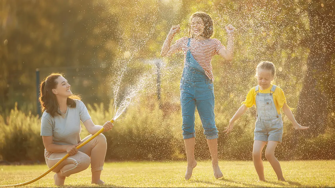 family playing in water